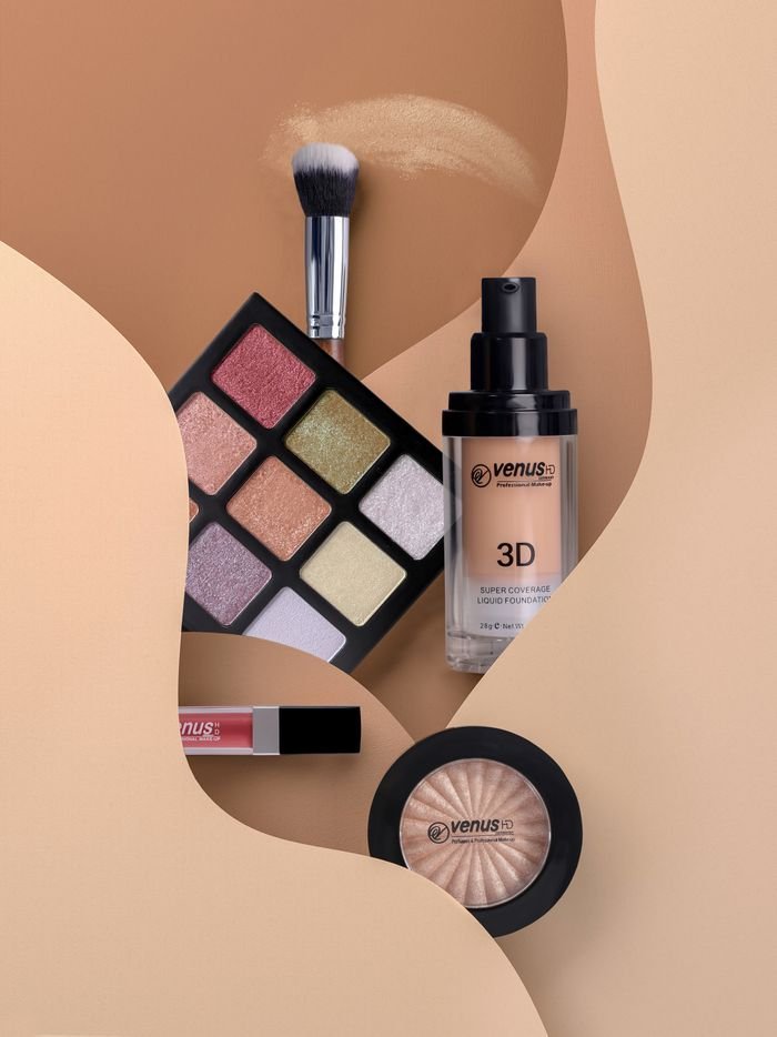 services-02 Flat lay of cosmetics including eyeshadow, lipstick, and blush with neutral tones.
